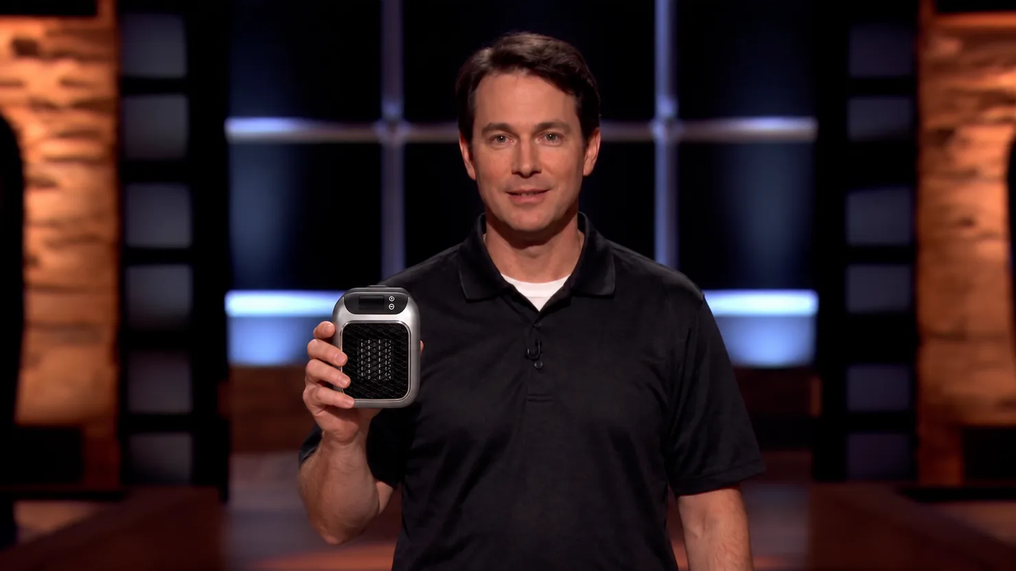 Man holding a compact portable heater